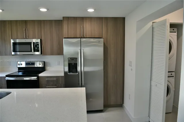a kitchen with cabinets and stainless steel appliances