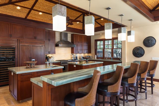 a kitchen with a dining table and chairs