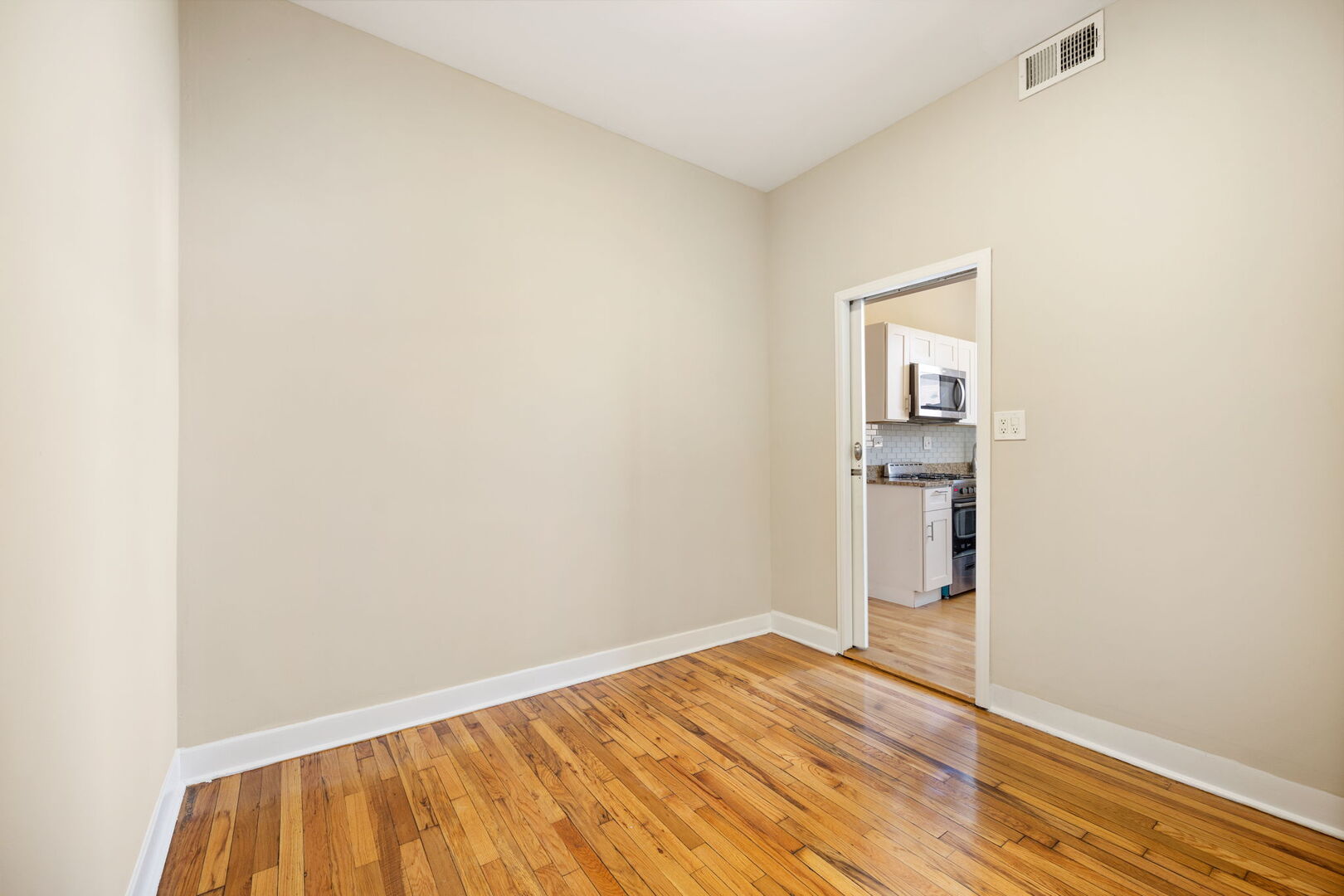 2242 North Western Avenue, Unit 2F Chicago, IL 60647 - Photo 12 of 12 a view of empty room with wooden floor