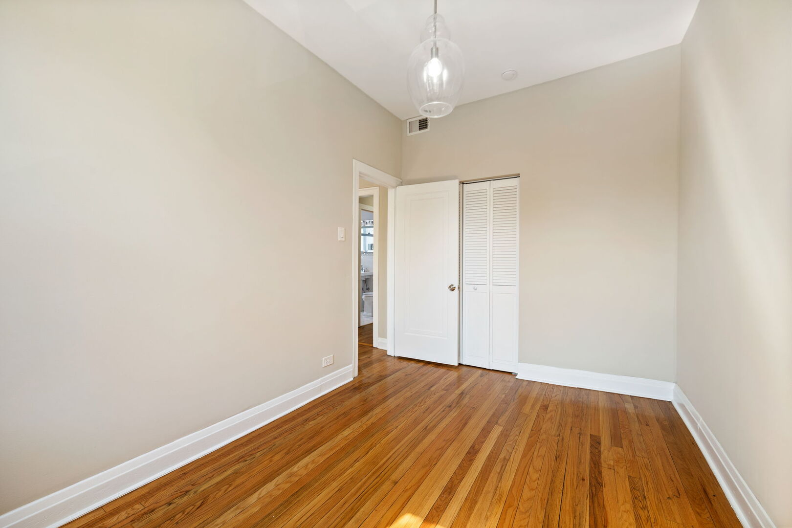 2242 North Western Avenue, Unit 2F Chicago, IL 60647 - Photo 9 of 12 a view of room with wooden floor and ceiling fan