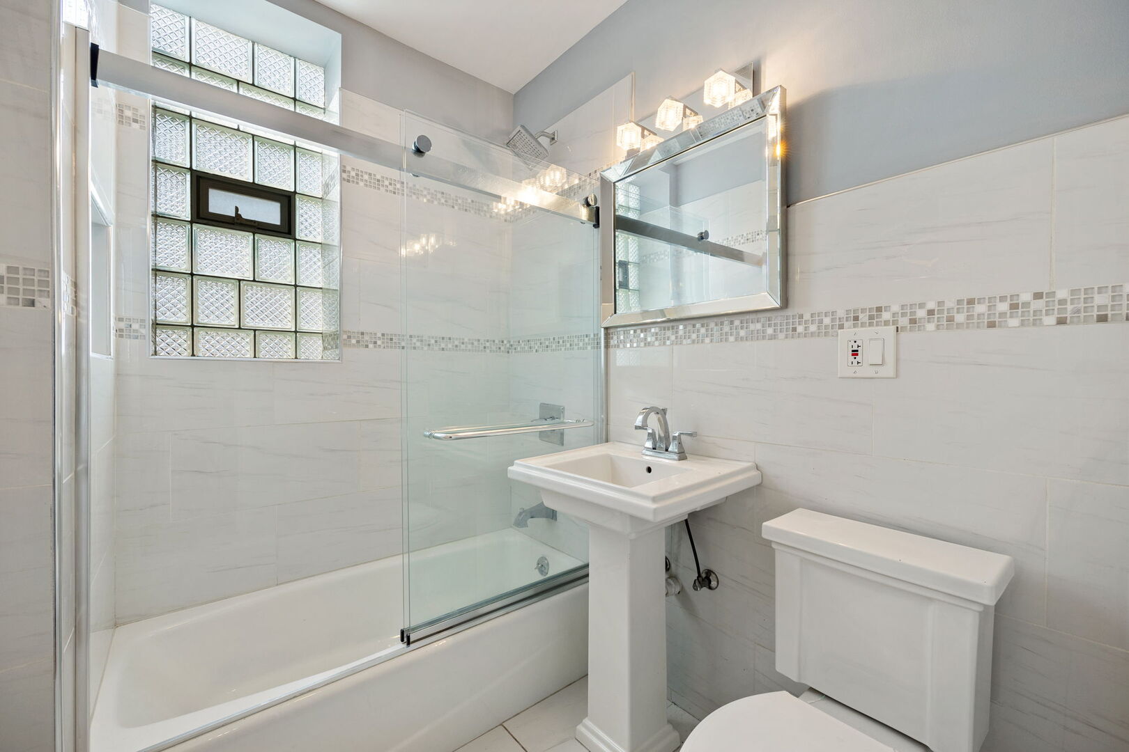 2242 North Western Avenue, Unit 2F Chicago, IL 60647 - Photo 10 of 12 a bathroom with a sink a toilet and shower