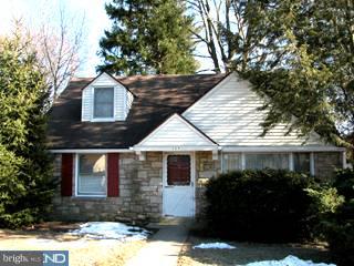 504 Filbert Road Oreland, PA 19075 - Photo 1 of 2 a front view of a house with a yard and garage