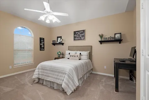 a bedroom with a bed and a chandelier