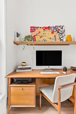 a living room with furniture potted plant and a window