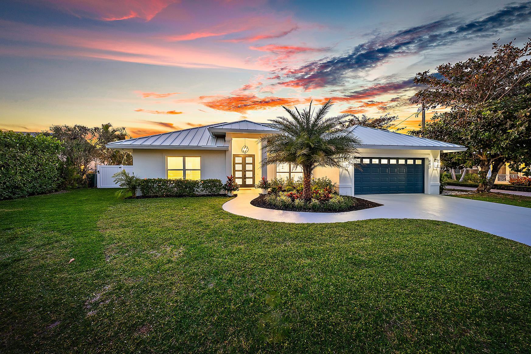 491 Sunset Way Juno Beach, FL 33408 - Photo 1 of 50 a front view of a house with a yard