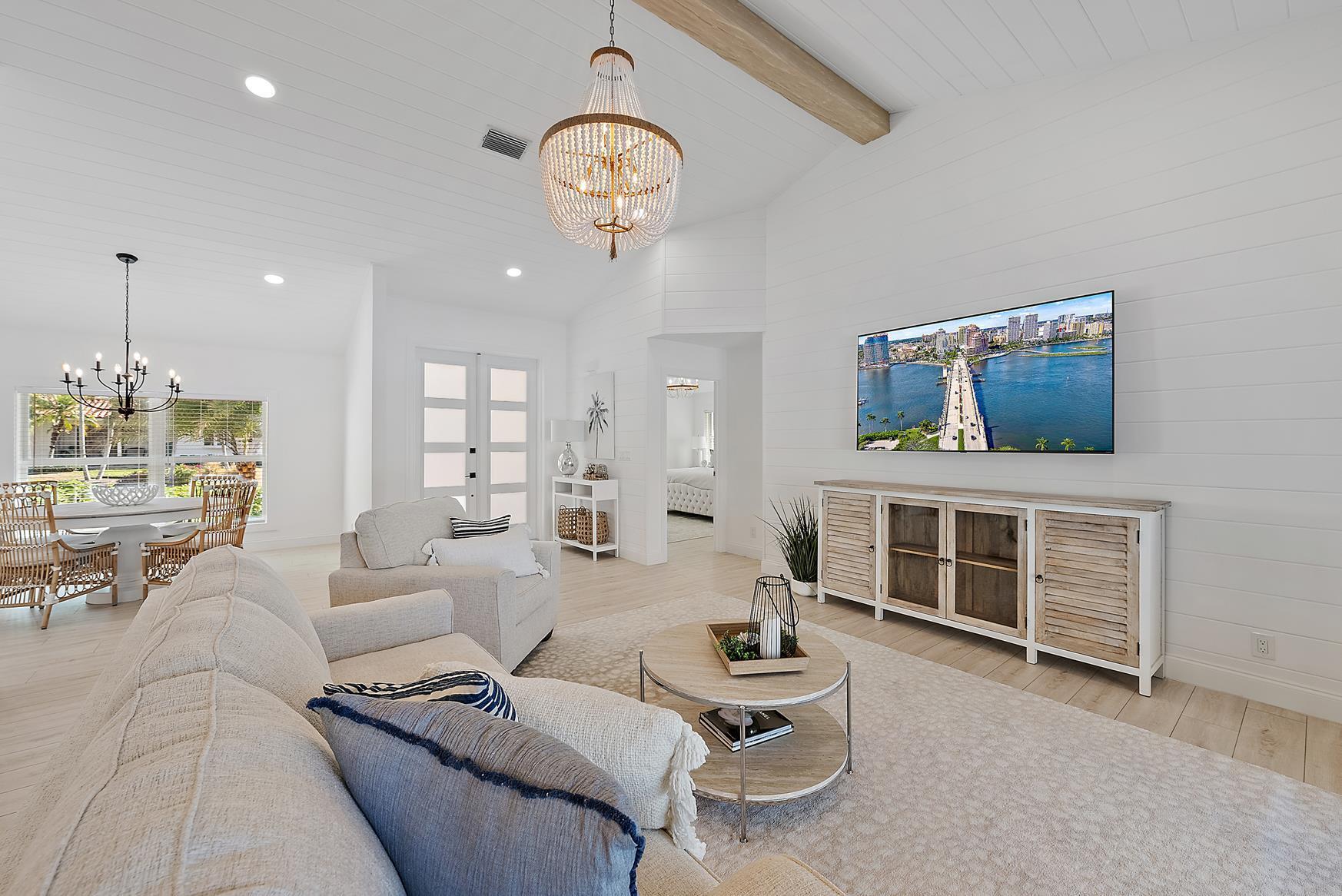 491 Sunset Way Juno Beach, FL 33408 - Photo 13 of 50 a living room with furniture a rug and kitchen view