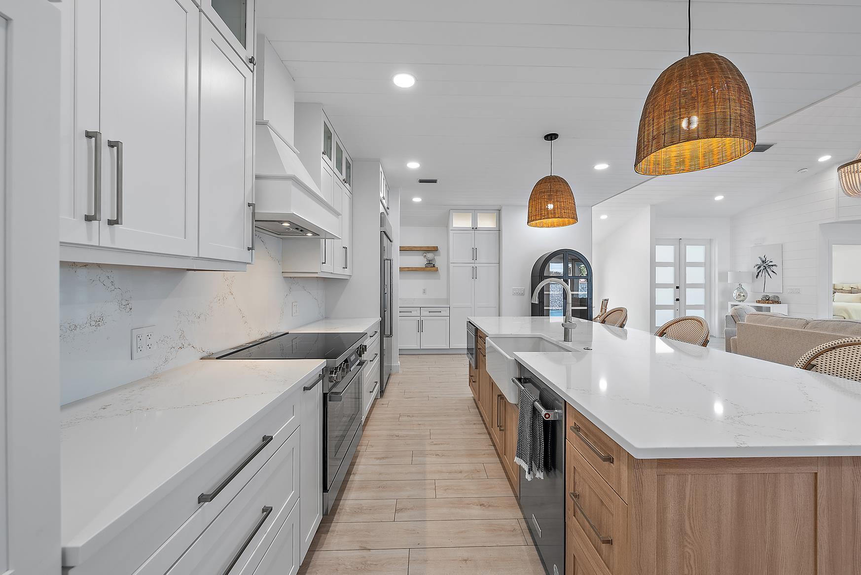 491 Sunset Way Juno Beach, FL 33408 - Photo 19 of 50 a large kitchen with stainless steel appliances lots of counter space and a sink