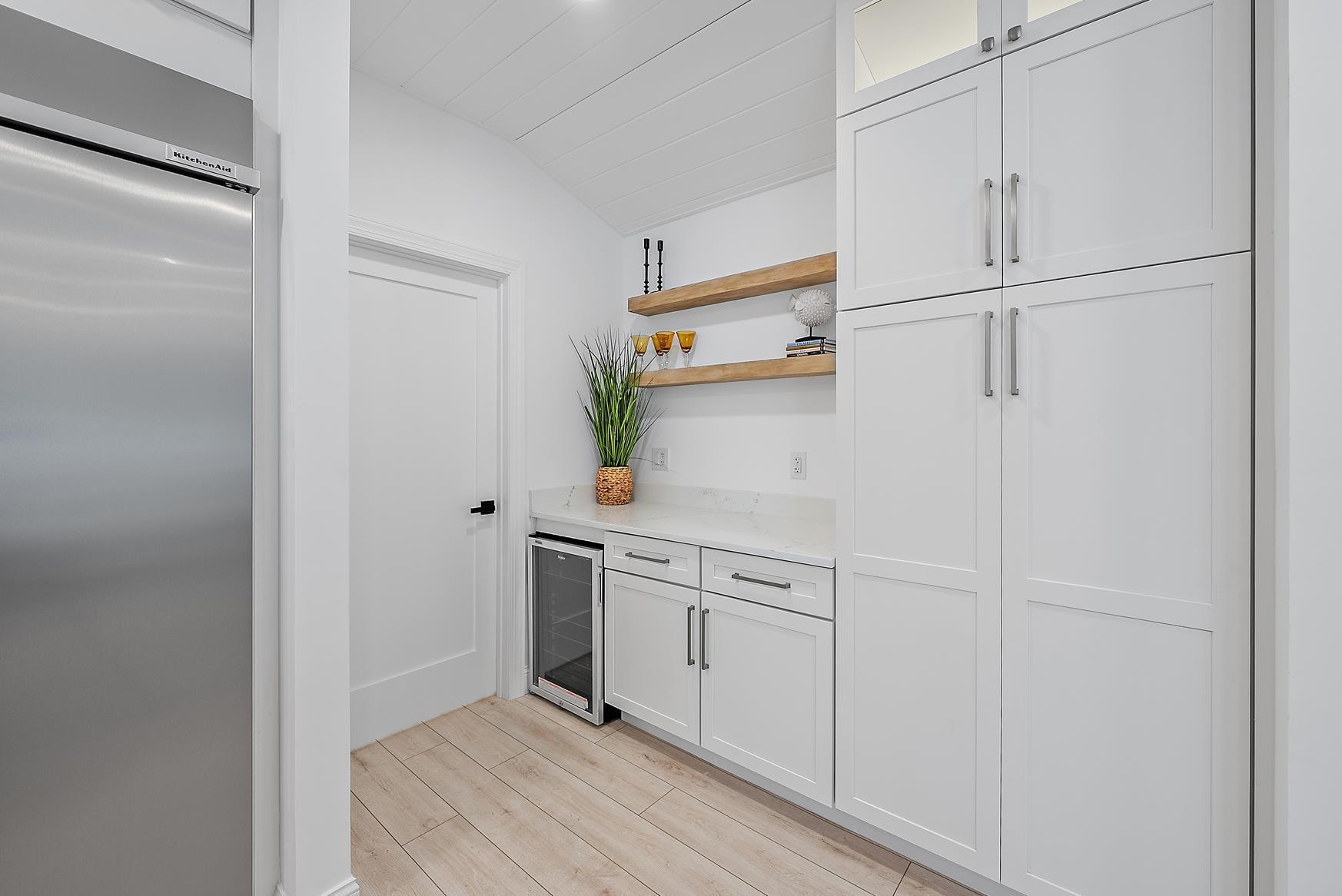 491 Sunset Way Juno Beach, FL 33408 - Photo 20 of 50 a kitchen with white cabinets and white appliances