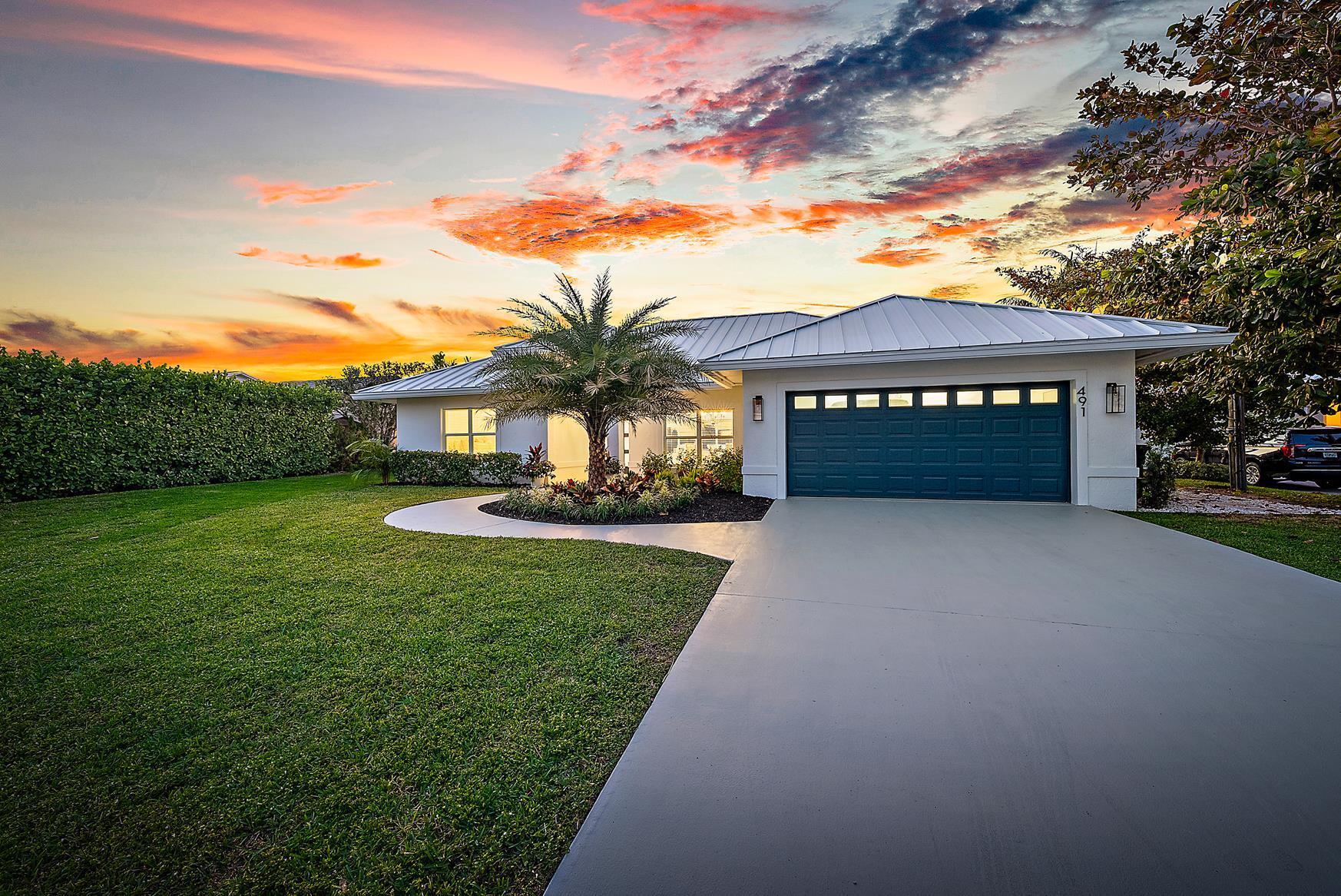 491 Sunset Way Juno Beach, FL 33408 - Photo 2 of 50 a front view of a house with a yard