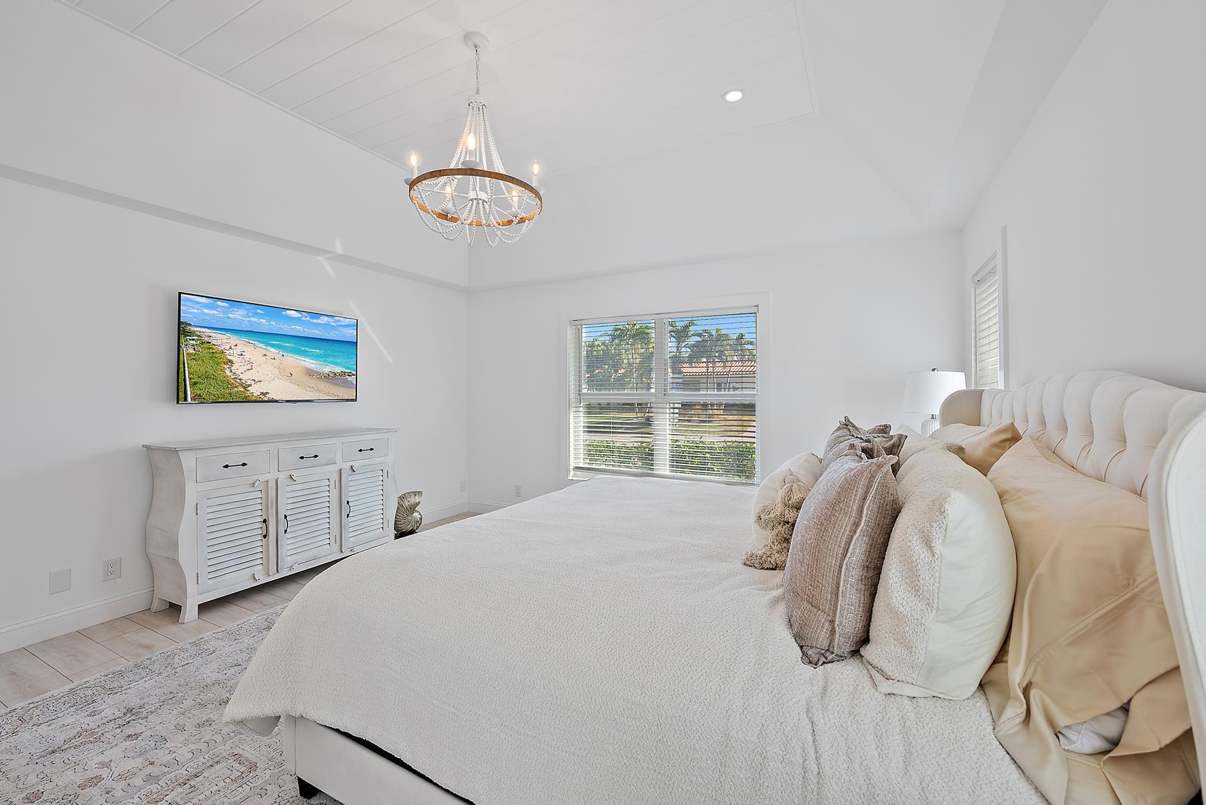 491 Sunset Way Juno Beach, FL 33408 - Photo 23 of 50 a bedroom with a bed and a window