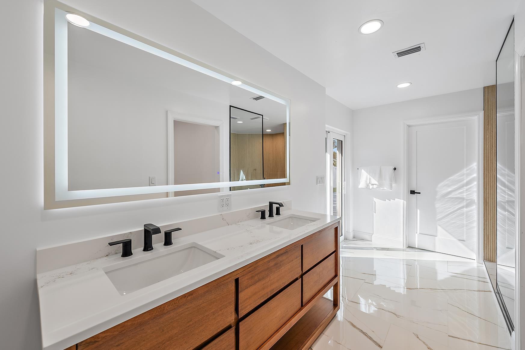 491 Sunset Way Juno Beach, FL 33408 - Photo 24 of 50 a bathroom with a sink vanity granite tub and a mirror