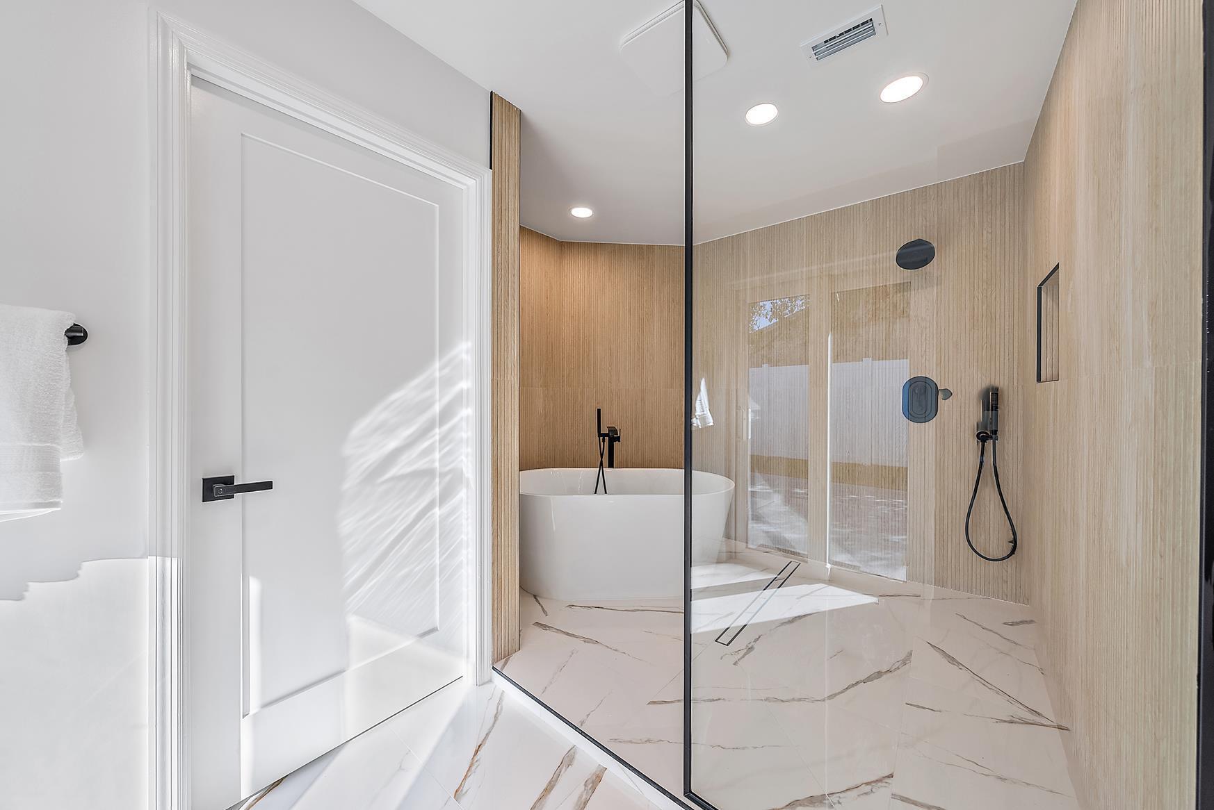 491 Sunset Way Juno Beach, FL 33408 - Photo 25 of 50 a bathroom with a glass shower door and a glass door