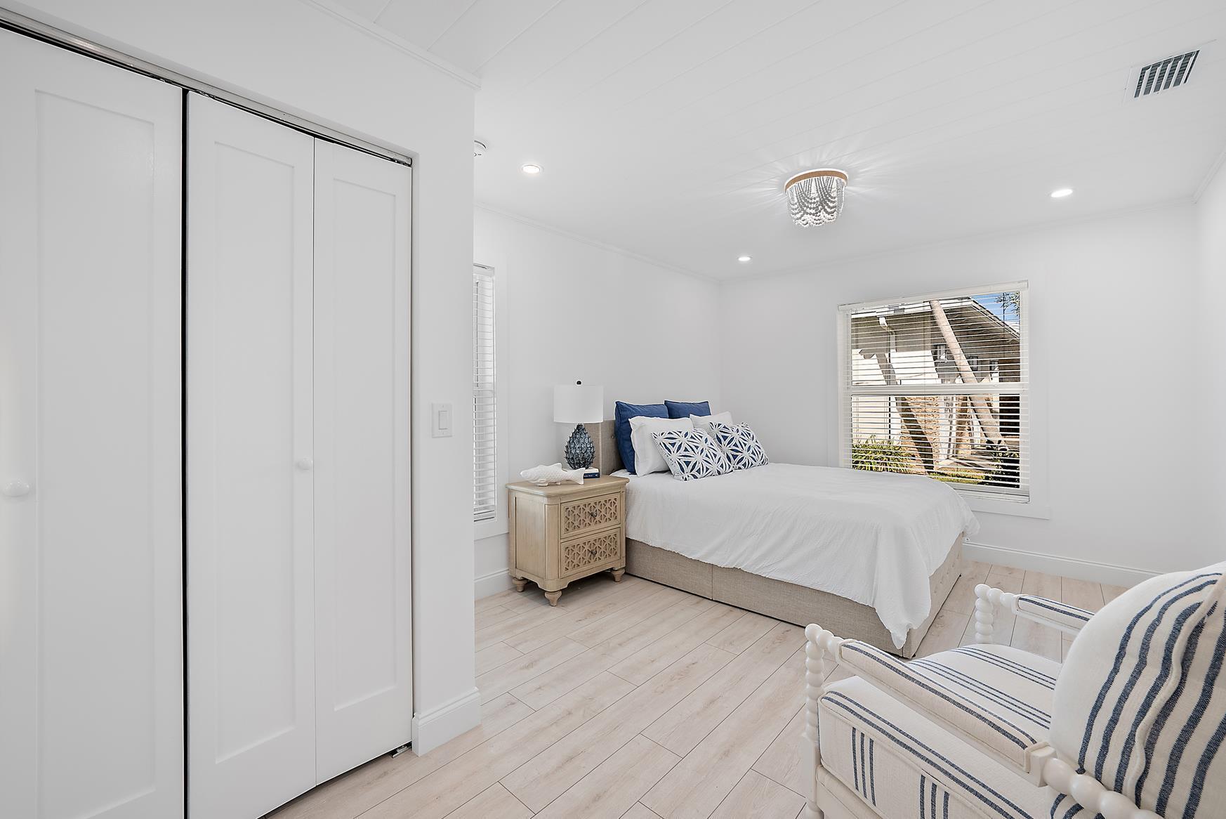 491 Sunset Way Juno Beach, FL 33408 - Photo 28 of 50 a spacious bedroom with a bed and wooden floor