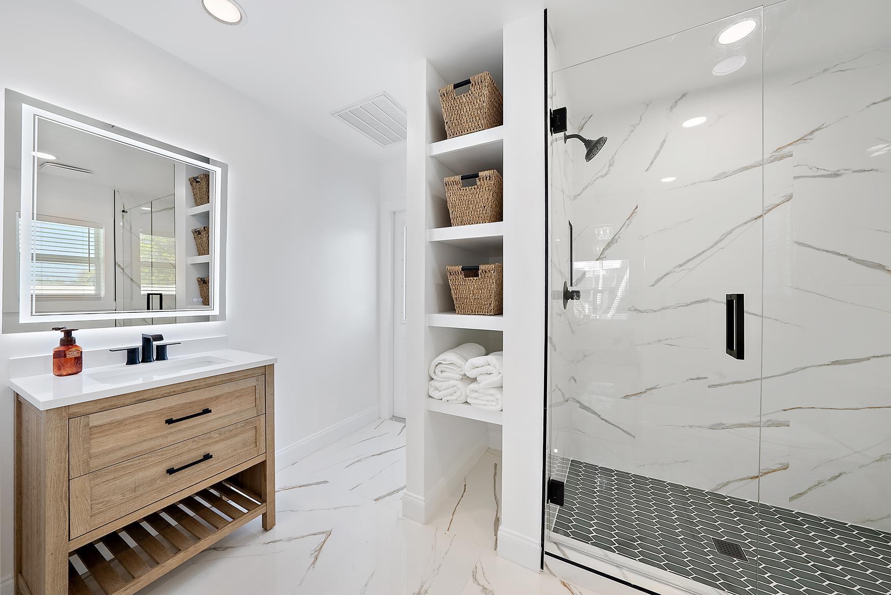 491 Sunset Way Juno Beach, FL 33408 - Photo 29 of 50 a bathroom with a double vanity sink a mirror and shower