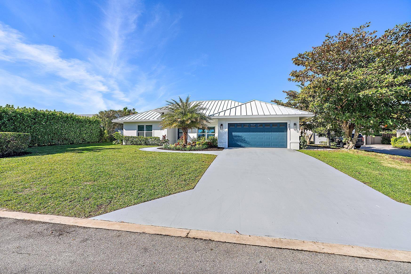 491 Sunset Way Juno Beach, FL 33408 - Photo 3 of 50 front view of a house with a yard