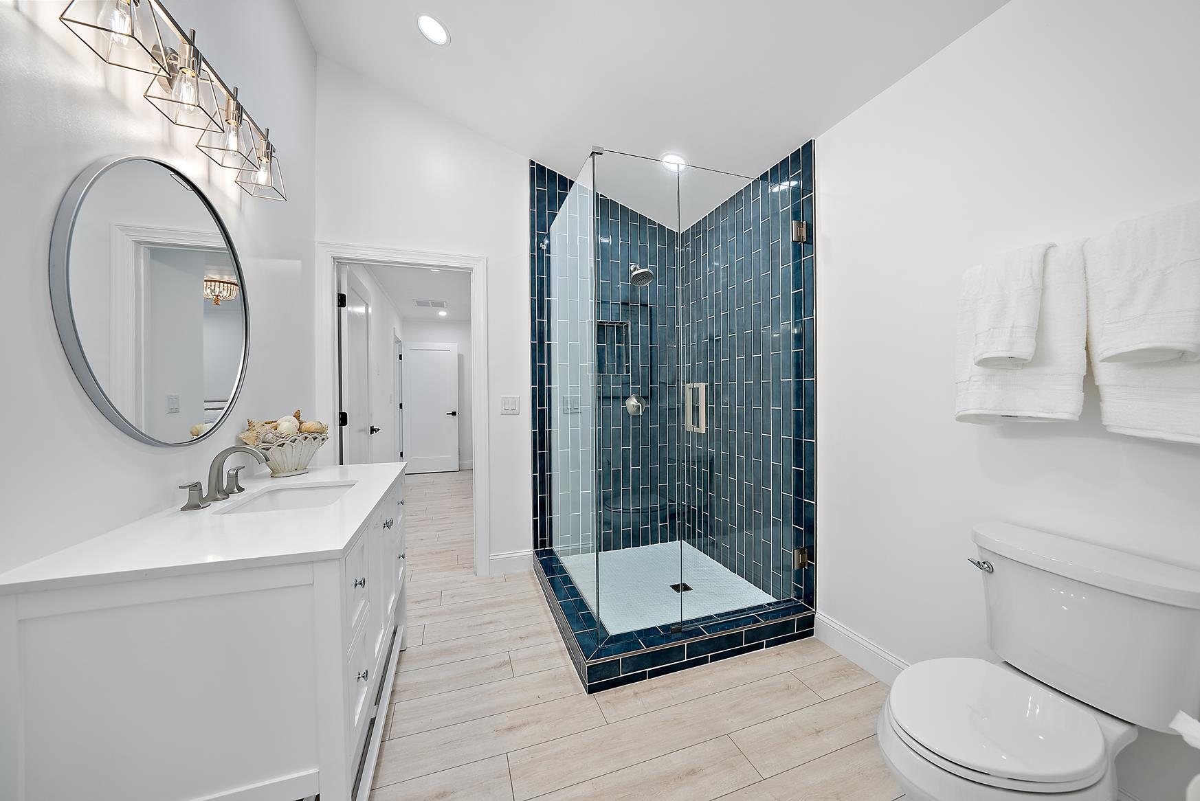 491 Sunset Way Juno Beach, FL 33408 - Photo 31 of 50 a bathroom with a sink a toilet and a mirror