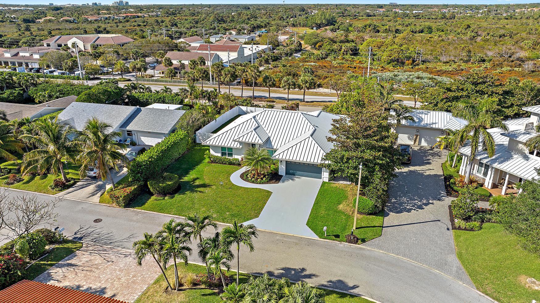 491 Sunset Way Juno Beach, FL 33408 - Photo 38 of 50 an aerial view of a house with a garden and lake view