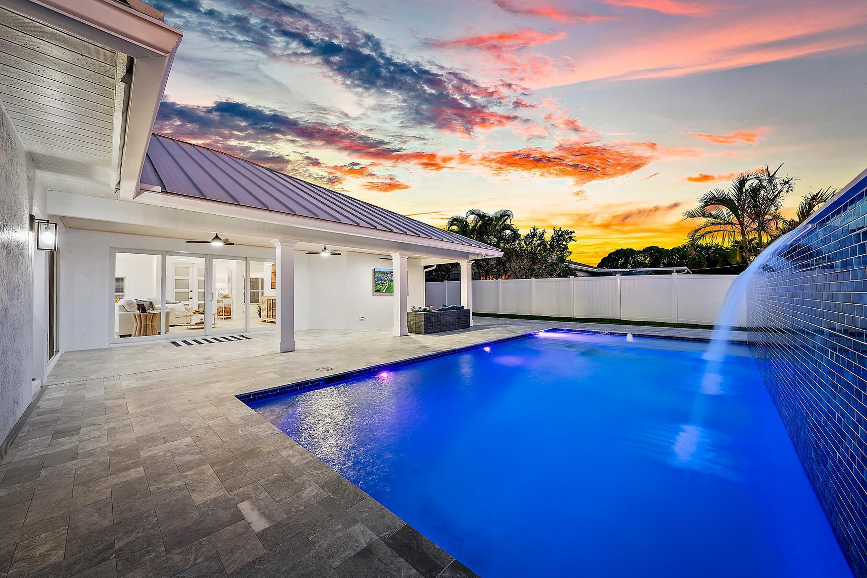 491 Sunset Way Juno Beach, FL 33408 - Photo 9 of 50 a view of a house with pool and sitting area