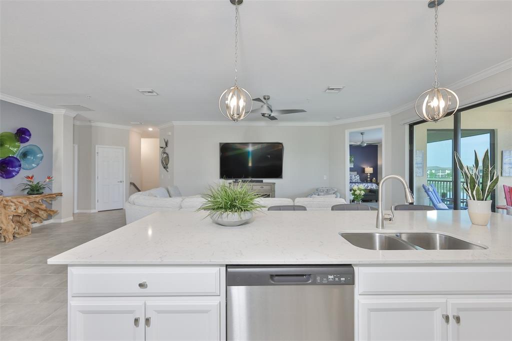 12405 Ghiberti Circle, Unit 202 Venice, FL 34293 - Photo 13 of 35 a kitchen with a sink and a large mirror