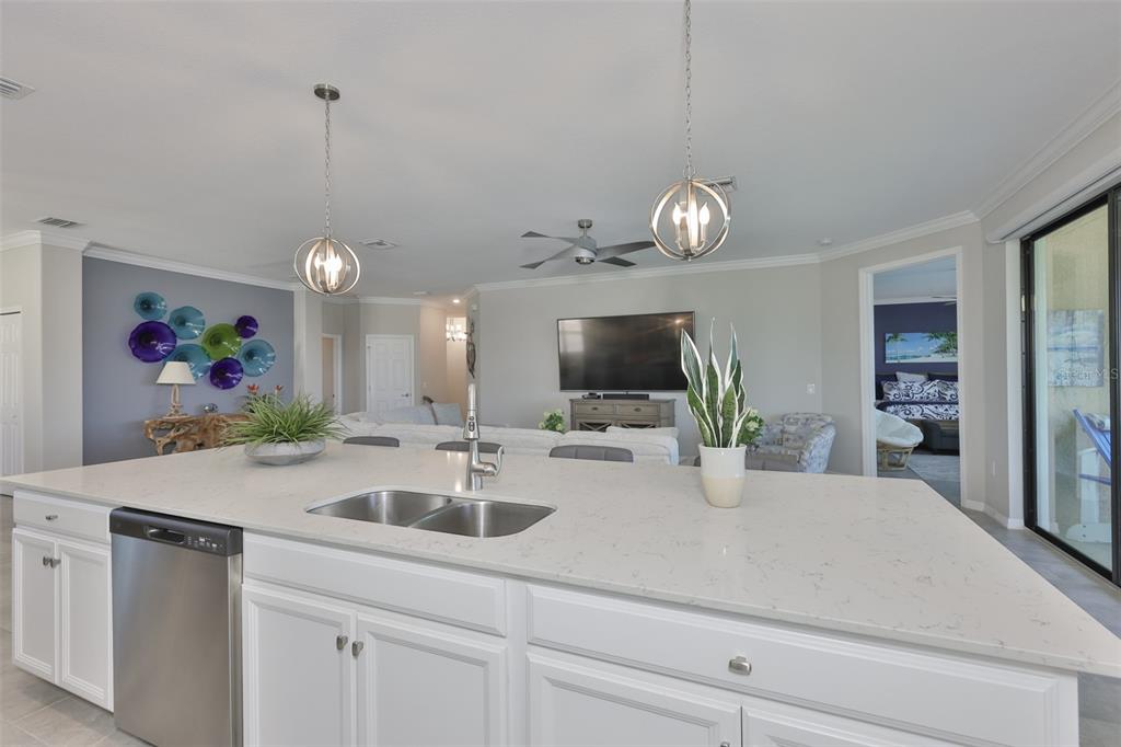 12405 Ghiberti Circle, Unit 202 Venice, FL 34293 - Photo 14 of 35 a kitchen with a sink a counter and living room view