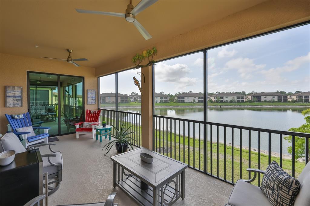 12405 Ghiberti Circle, Unit 202 Venice, FL 34293 - Photo 19 of 35 a living room with furniture and floor to ceiling windows