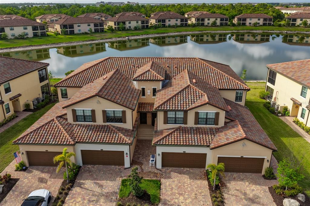 12405 Ghiberti Circle, Unit 202 Venice, FL 34293 - Photo 2 of 35 an aerial view of a house with a lake view