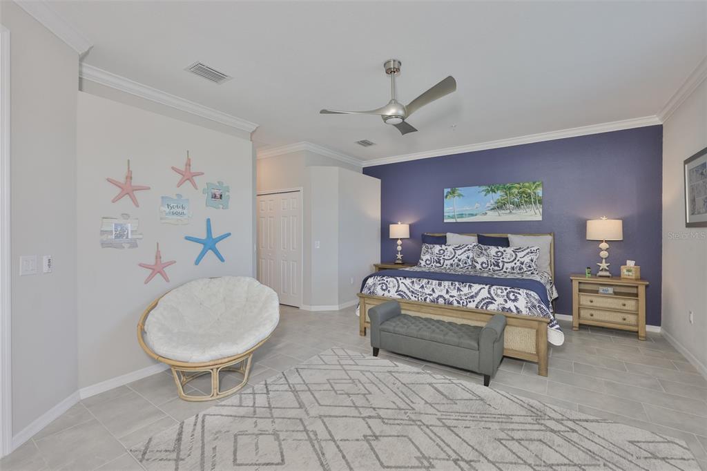 12405 Ghiberti Circle, Unit 202 Venice, FL 34293 - Photo 22 of 35 a bedroom with a bed and a mirror