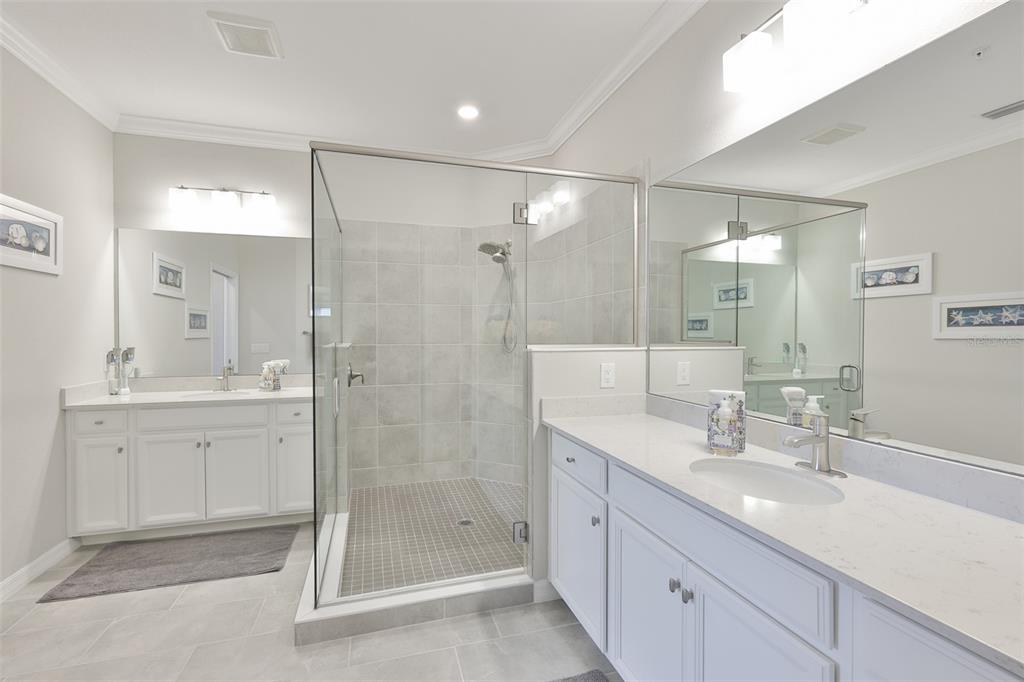 12405 Ghiberti Circle, Unit 202 Venice, FL 34293 - Photo 23 of 35 a bathroom with a shower sink double and mirror