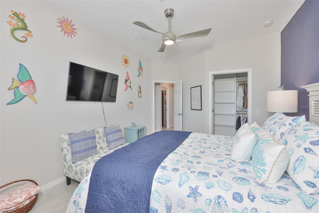 12405 Ghiberti Circle, Unit 202 Venice, FL 34293 - Photo 30 of 35 a bedroom with a bed and a flat screen tv