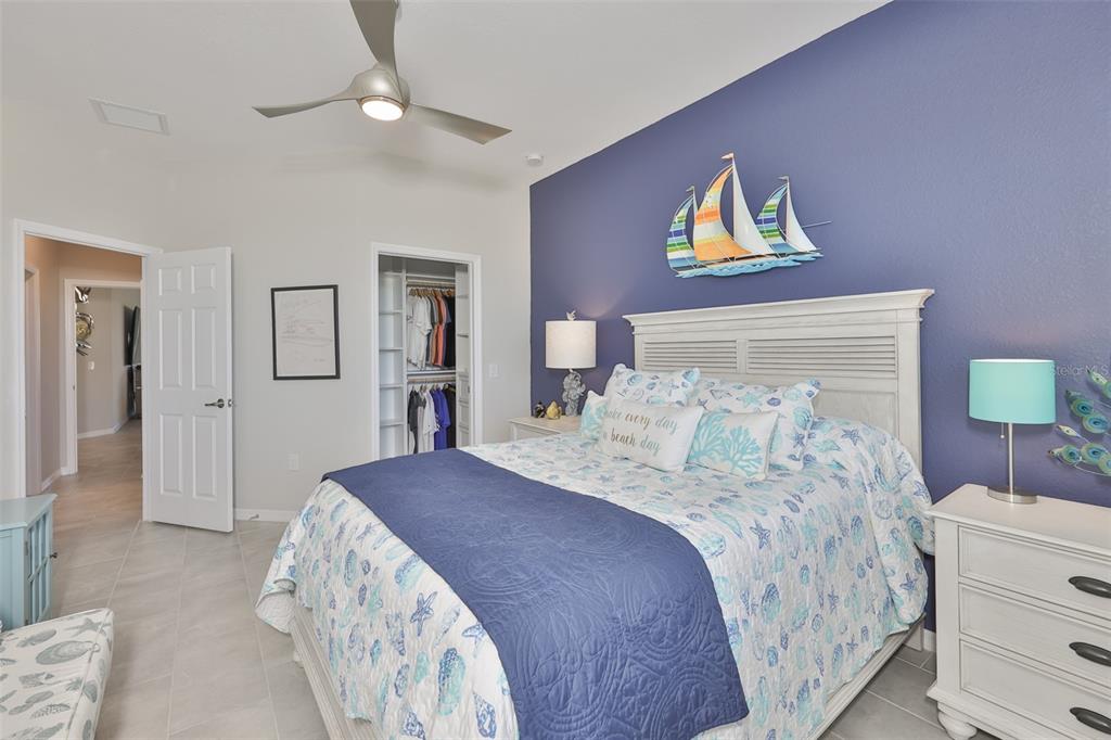 12405 Ghiberti Circle, Unit 202 Venice, FL 34293 - Photo 31 of 35 a bedroom with a bed and a lamp on dresser