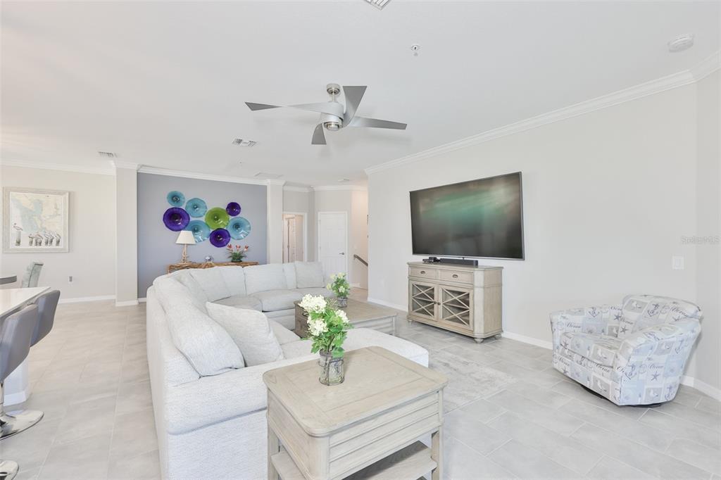 12405 Ghiberti Circle, Unit 202 Venice, FL 34293 - Photo 10 of 35 a living room with furniture and a flat screen tv