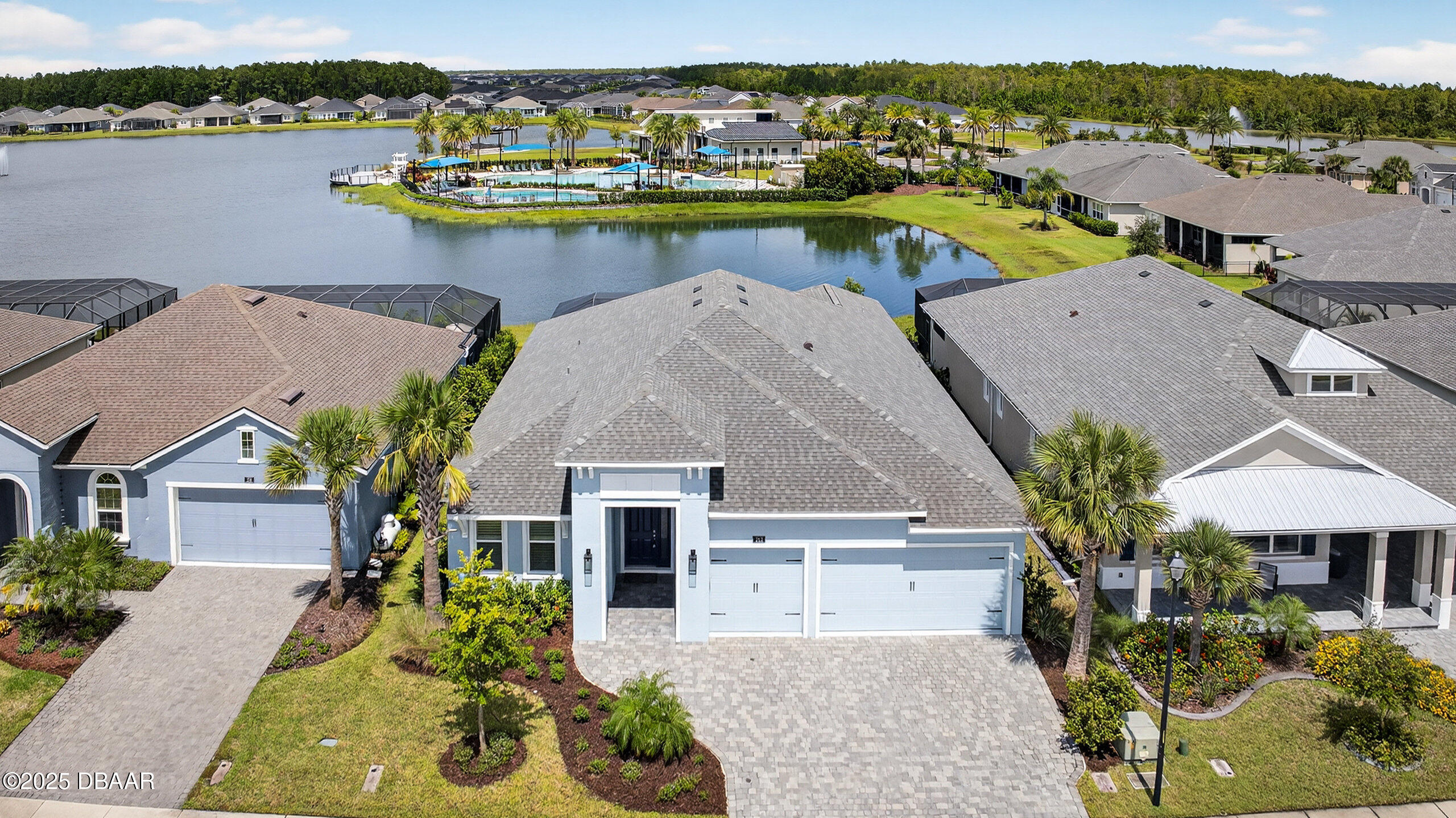 a view of a house with pool and chairs
