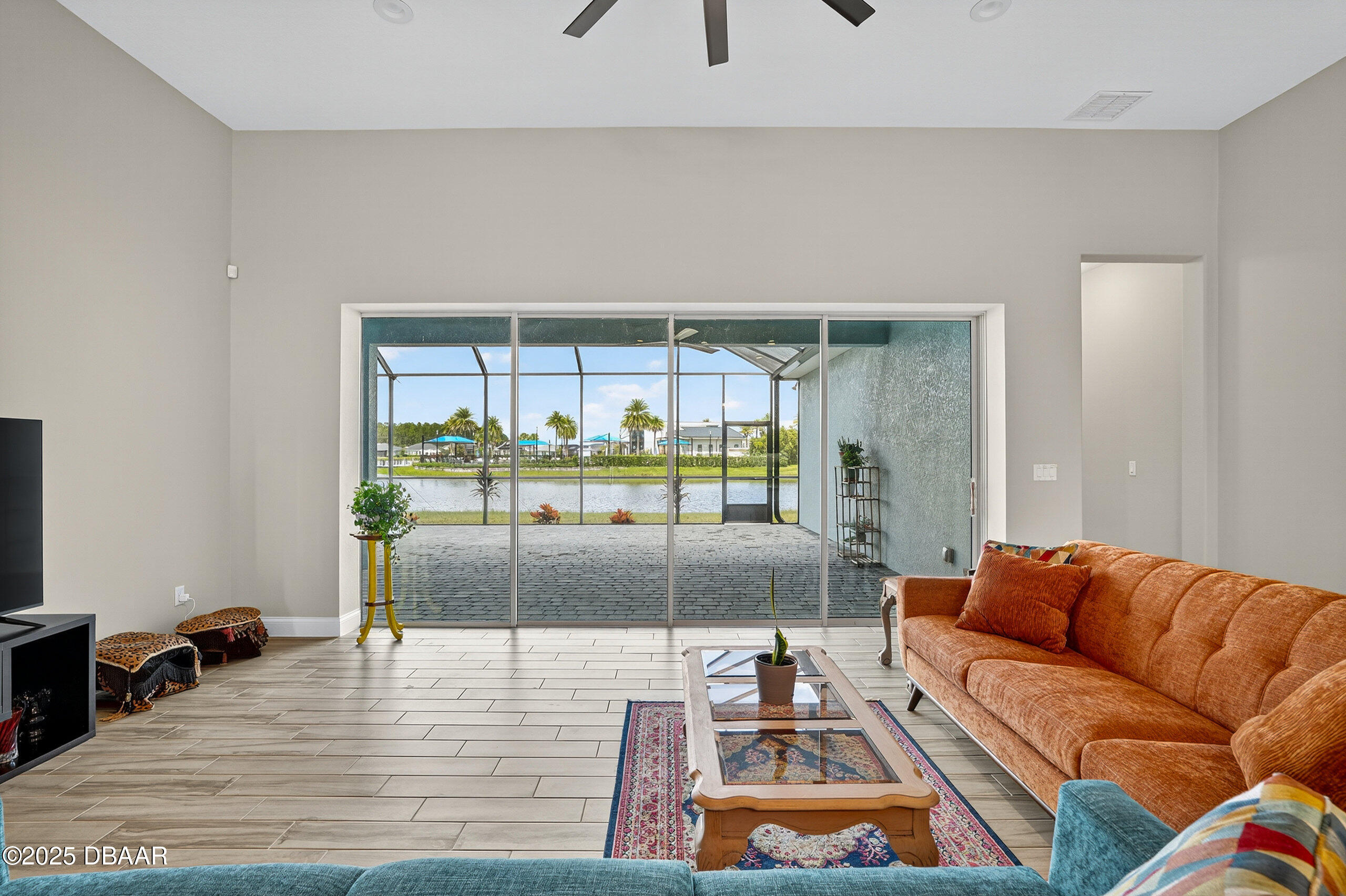 212 Fuchsia Street Daytona Beach, FL 32124 - Photo 12 of 54 a living room with furniture and a floor to ceiling window