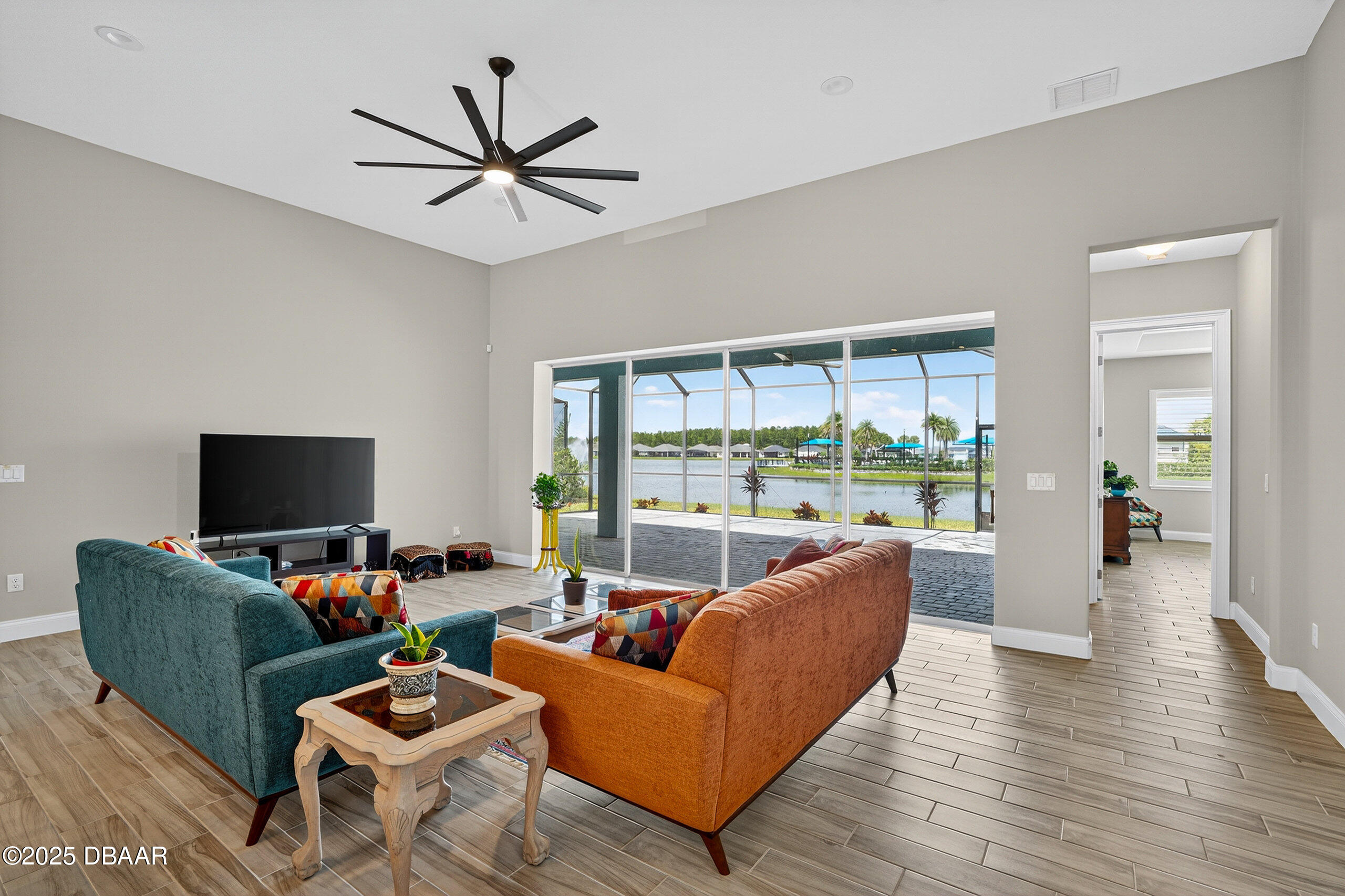 212 Fuchsia Street Daytona Beach, FL 32124 - Photo 14 of 54 a living room with furniture a ceiling fan a fireplace and a large window