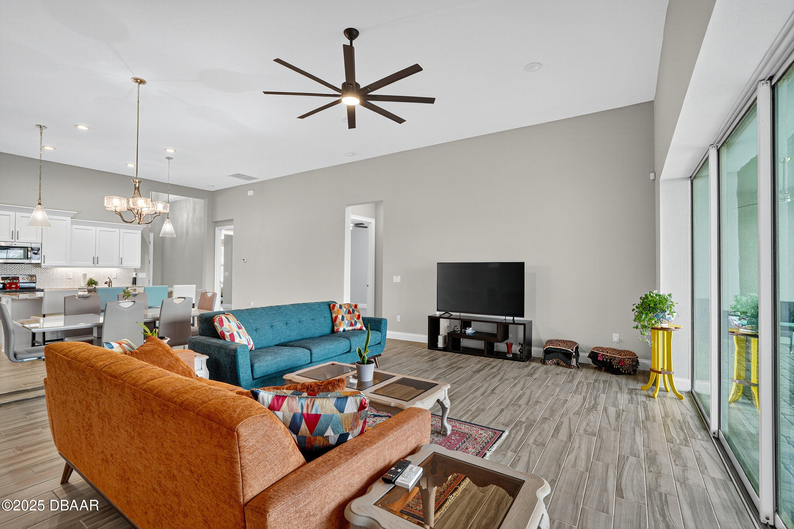 212 Fuchsia Street Daytona Beach, FL 32124 - Photo 15 of 54 a living room with furniture and a flat screen tv