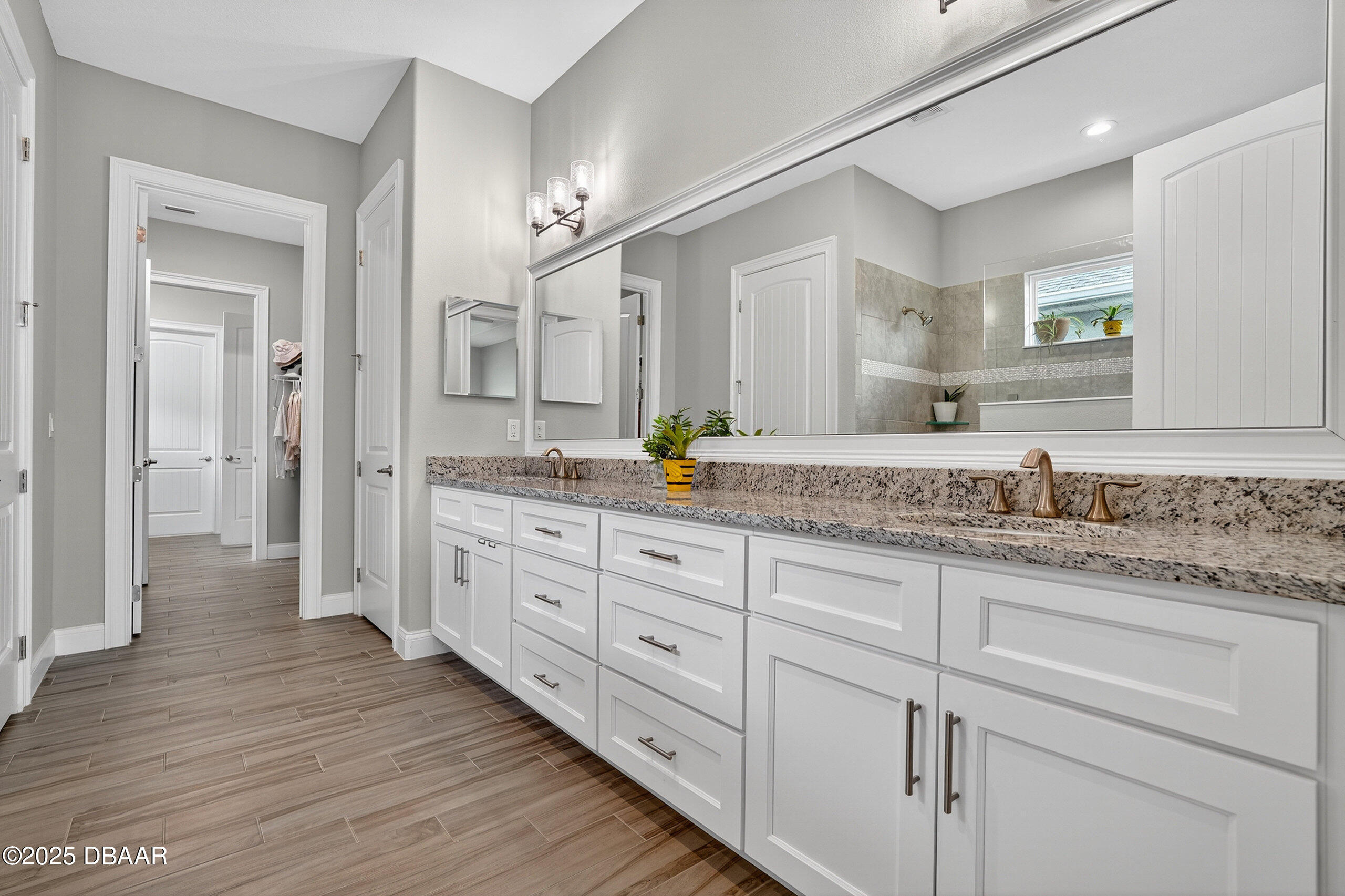 212 Fuchsia Street Daytona Beach, FL 32124 - Photo 24 of 54 a spacious bathroom with double sink and a large mirror