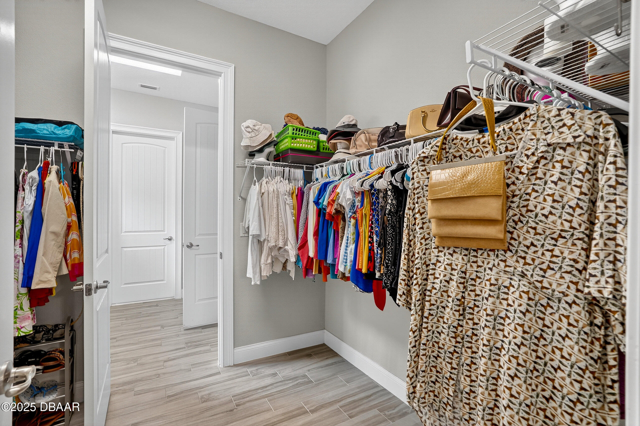 212 Fuchsia Street Daytona Beach, FL 32124 - Photo 27 of 54 a view of walk in closet with clothes