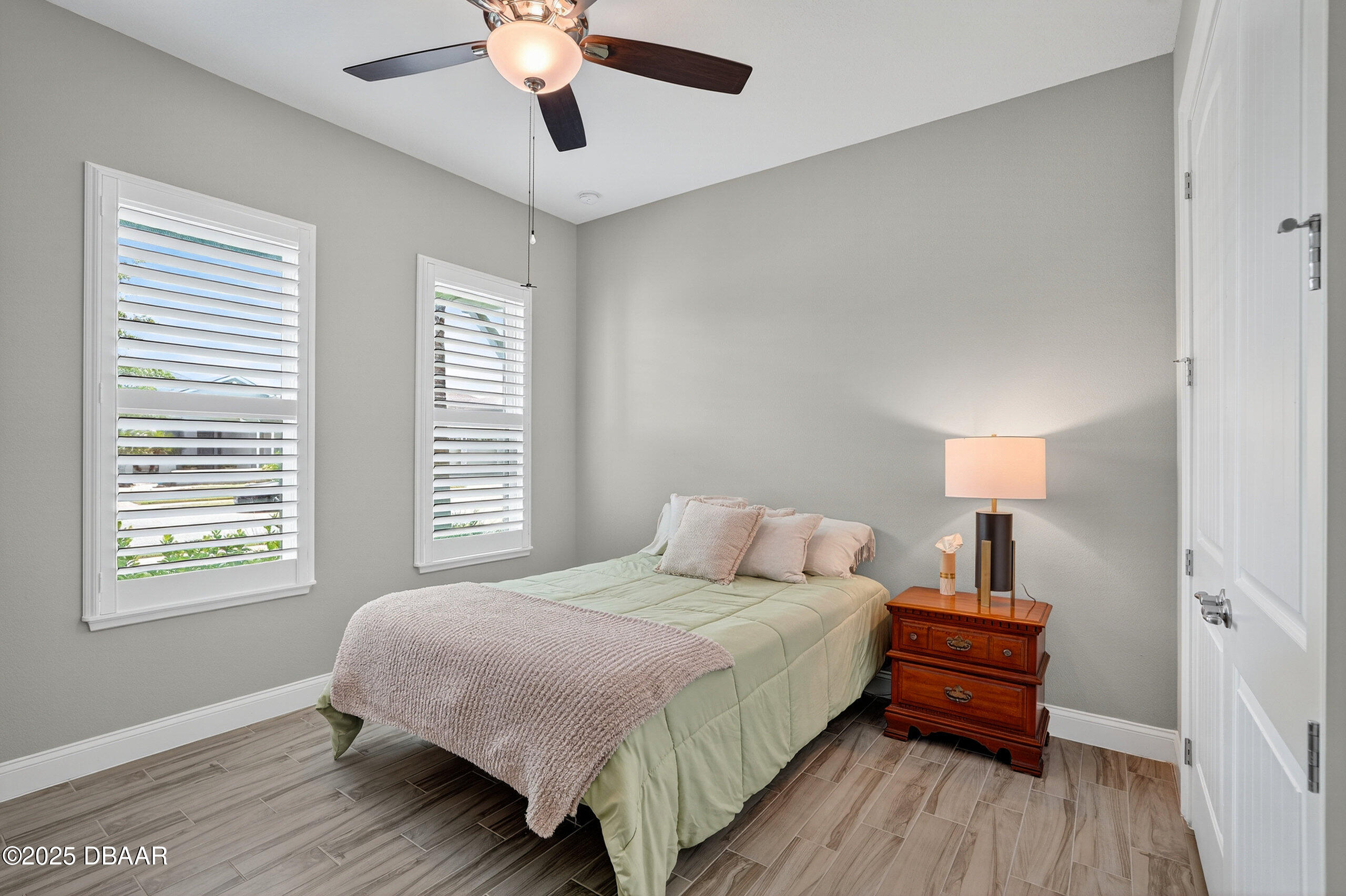212 Fuchsia Street Daytona Beach, FL 32124 - Photo 29 of 54 a bedroom with a bed wooden floor and window
