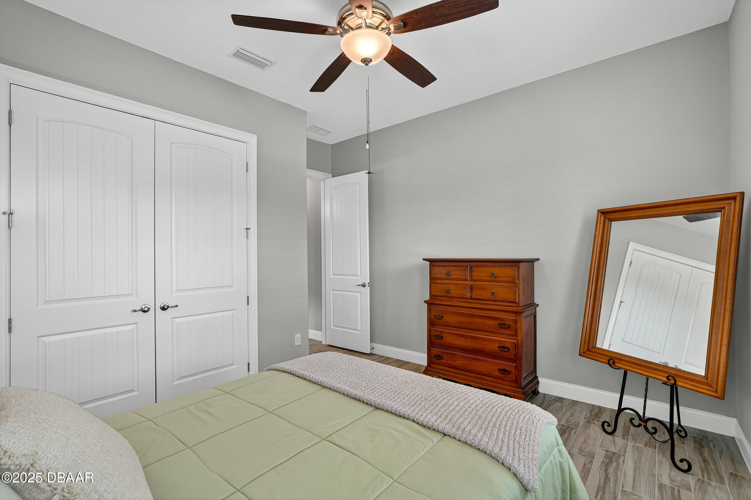 212 Fuchsia Street Daytona Beach, FL 32124 - Photo 30 of 54 a bedroom with a bed and a chandelier