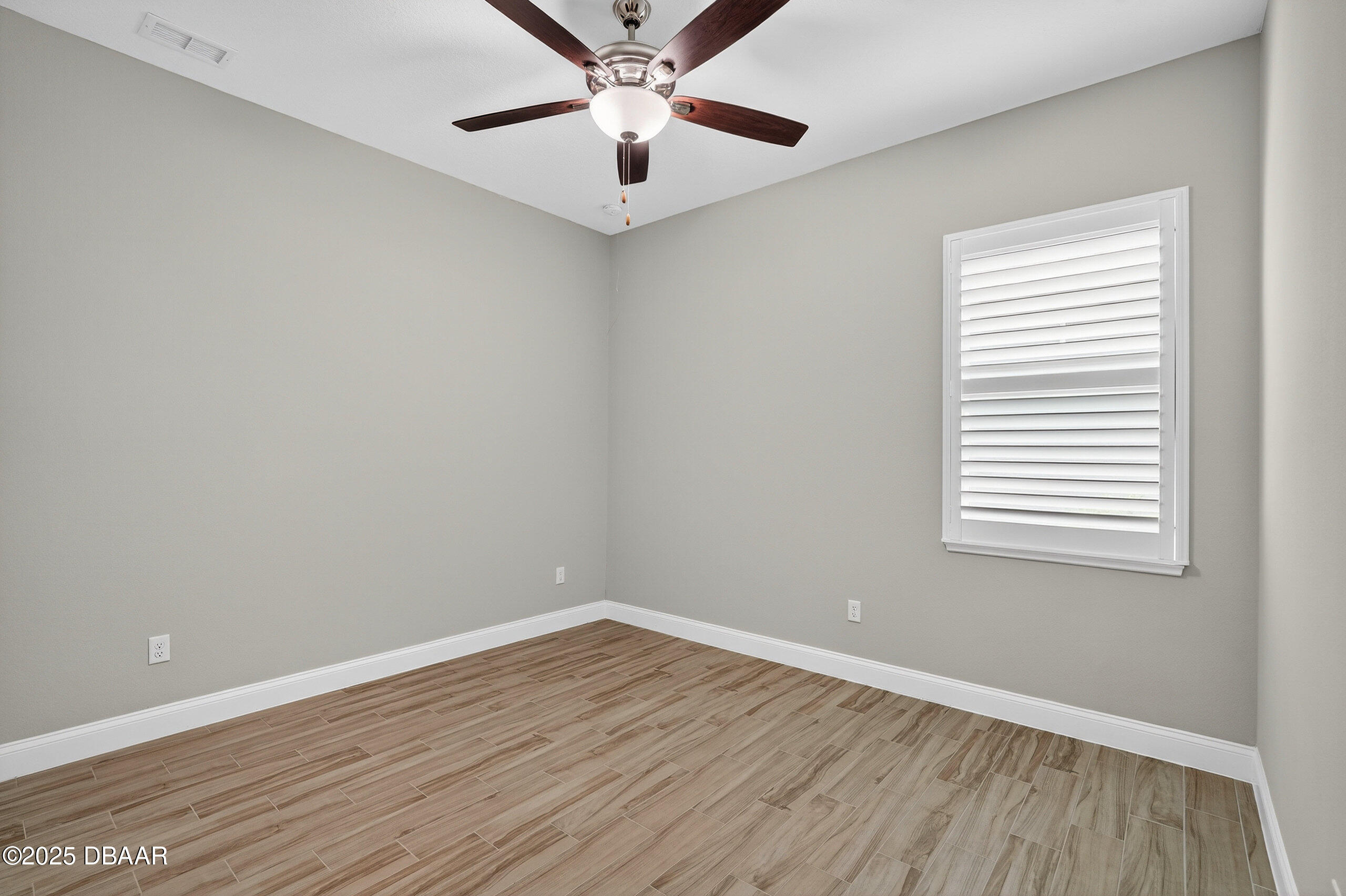 212 Fuchsia Street Daytona Beach, FL 32124 - Photo 32 of 54 wooden floor in an empty room with a window