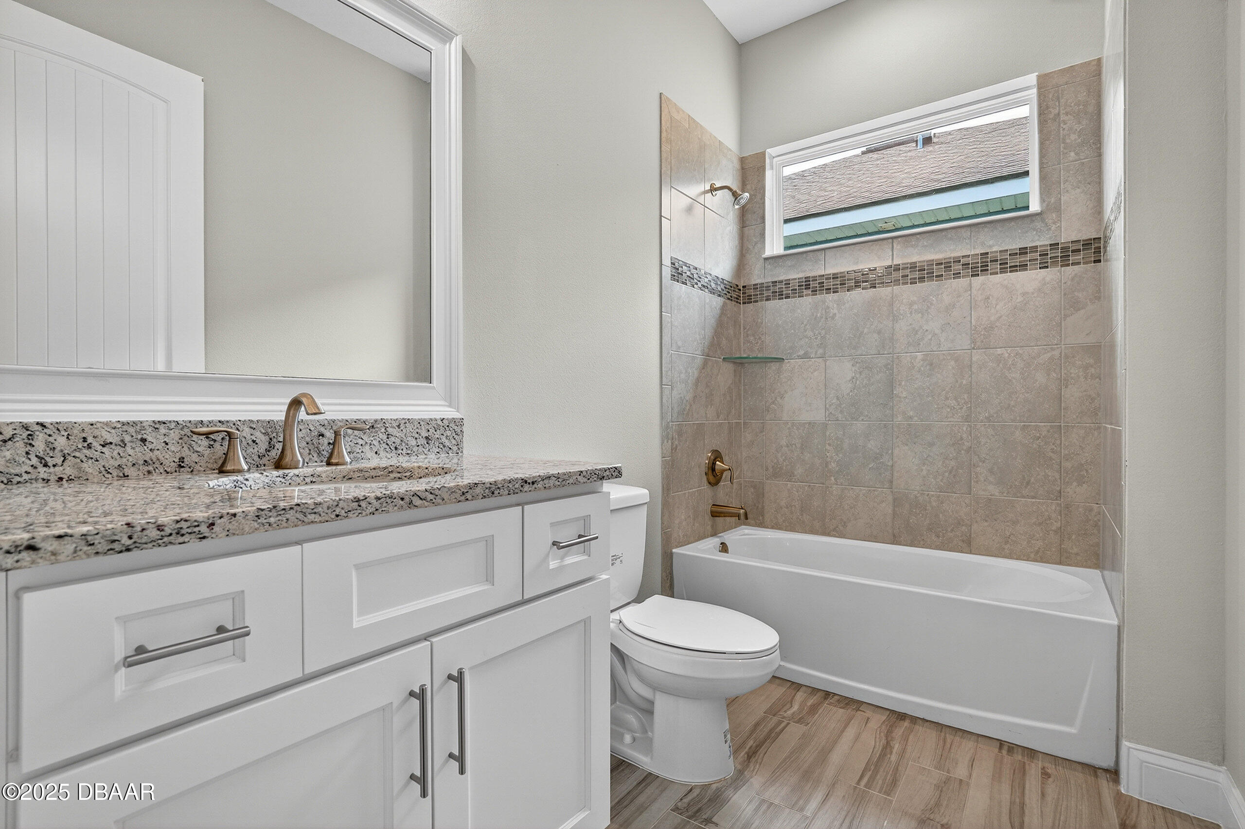 212 Fuchsia Street Daytona Beach, FL 32124 - Photo 34 of 54 a bathroom with a granite countertop sink a toilet and shower