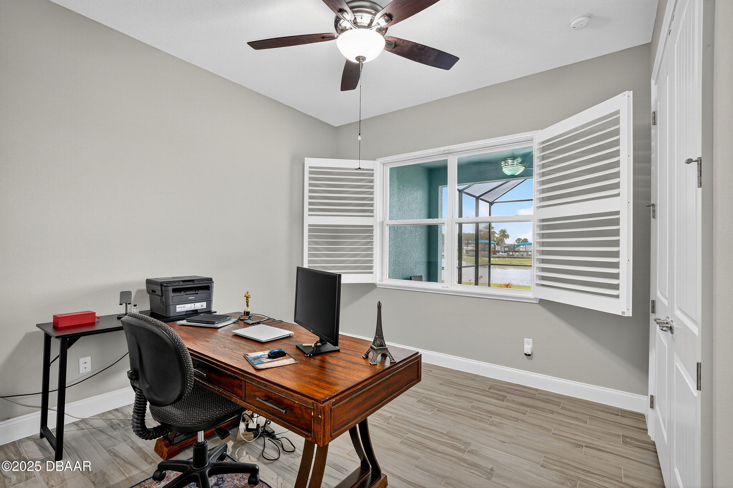 212 Fuchsia Street Daytona Beach, FL 32124 - Photo 36 of 54 a view of a workspace with furniture and a window