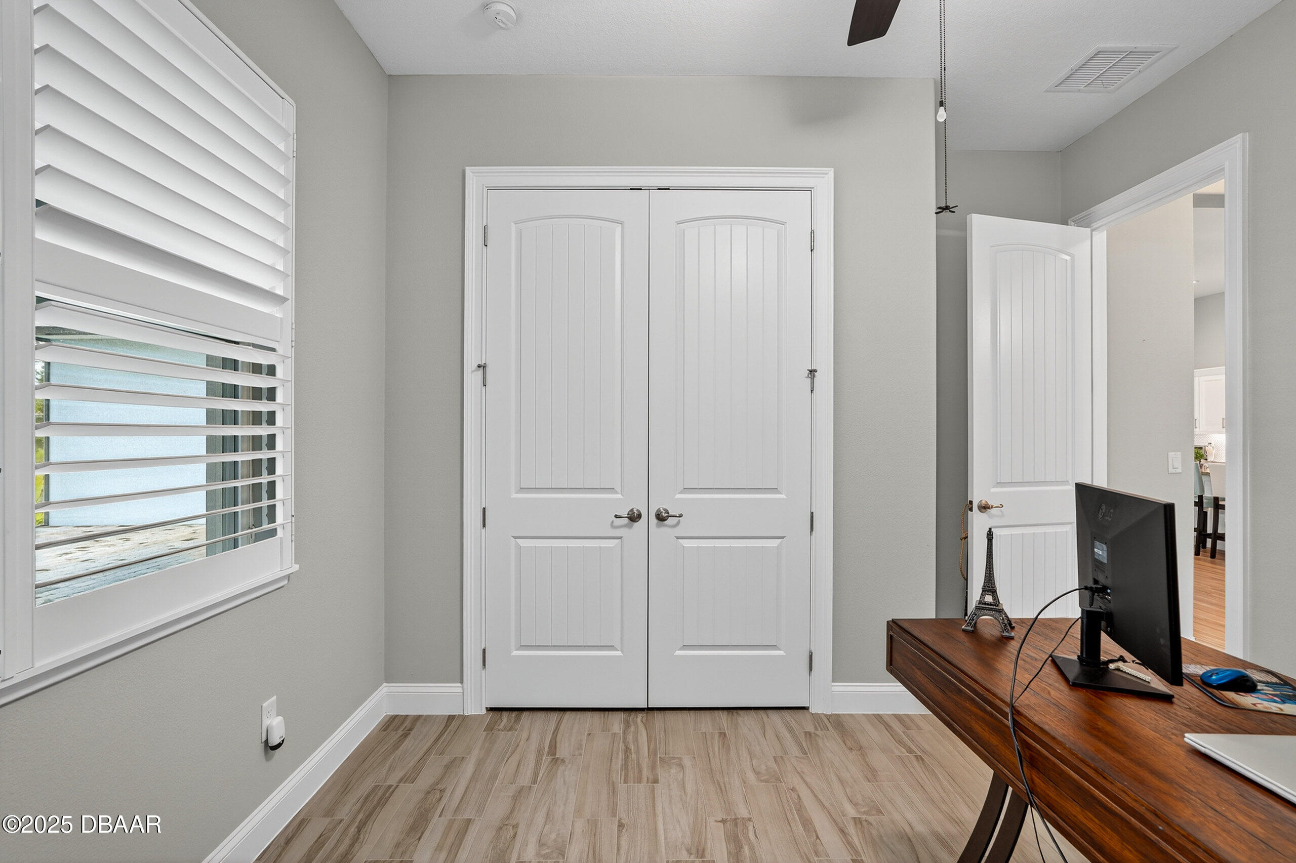 212 Fuchsia Street Daytona Beach, FL 32124 - Photo 37 of 54 a view of room with a flat screen tv and wooden floor