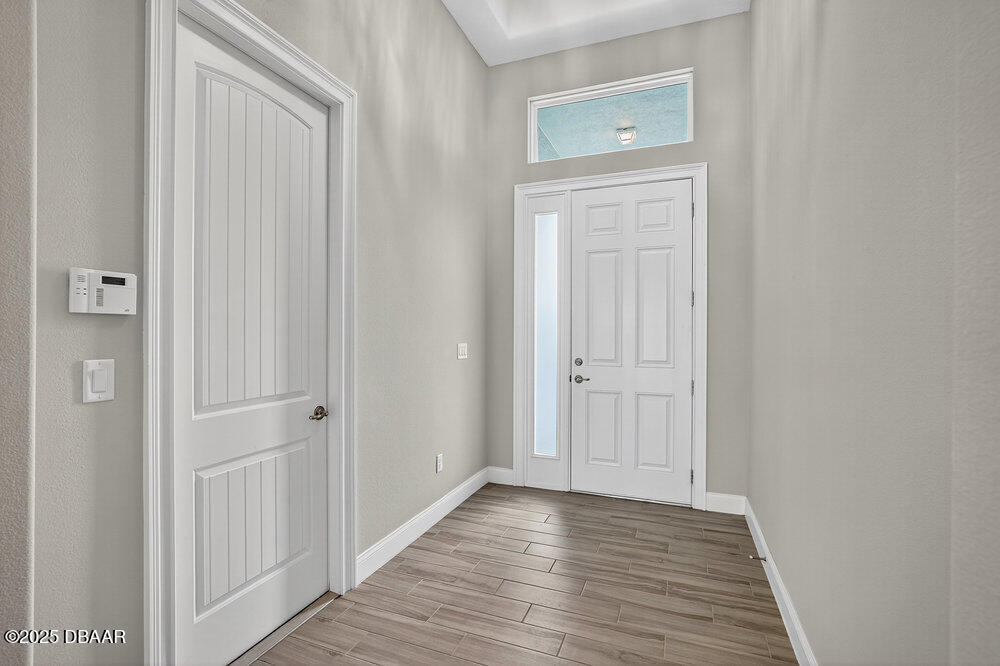 212 Fuchsia Street Daytona Beach, FL 32124 - Photo 4 of 54 a view of a hallway with wooden floor