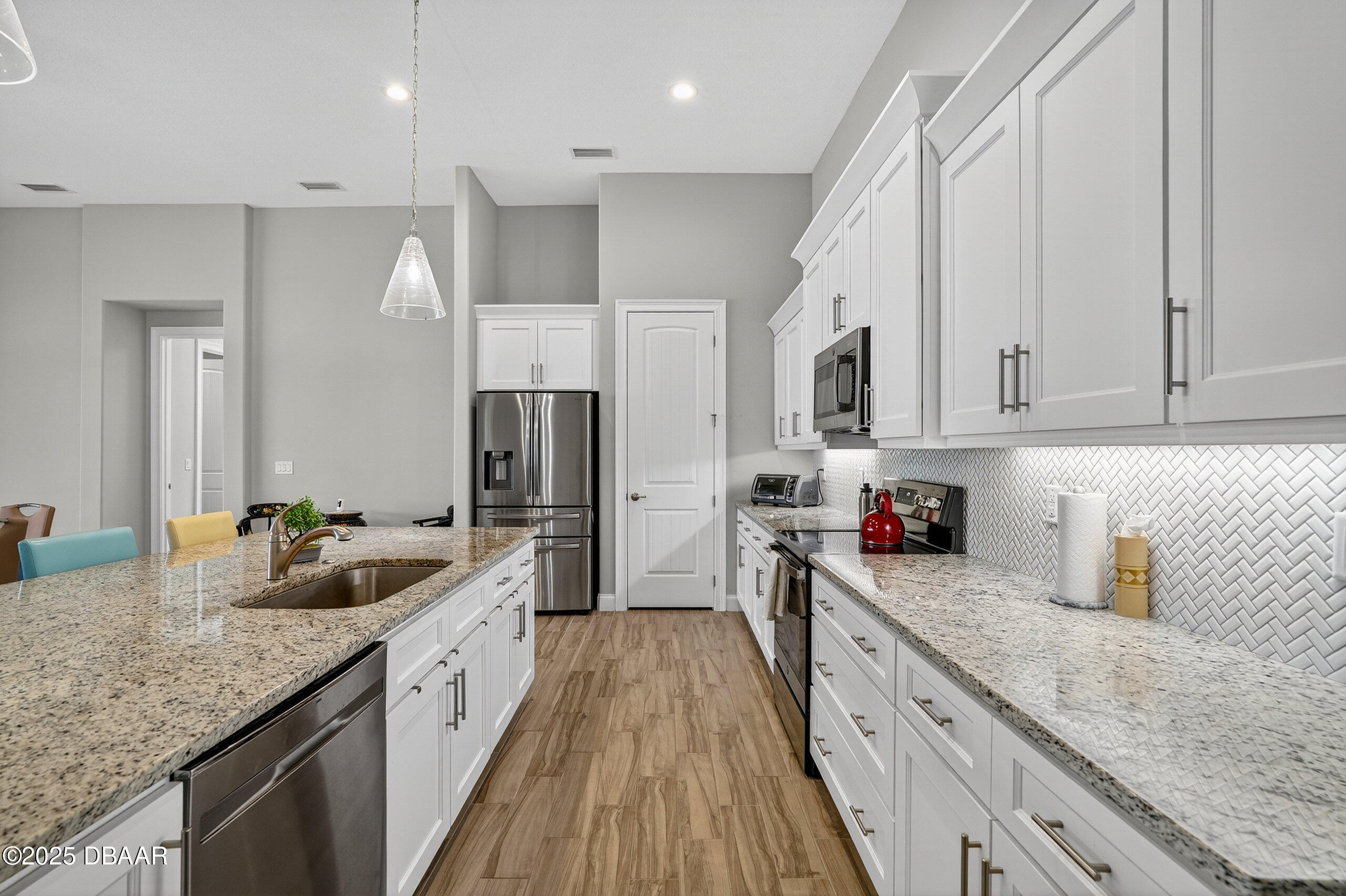 212 Fuchsia Street Daytona Beach, FL 32124 - Photo 6 of 54 a kitchen with granite countertop a sink dishwasher stove and refrigerator with wooden floor