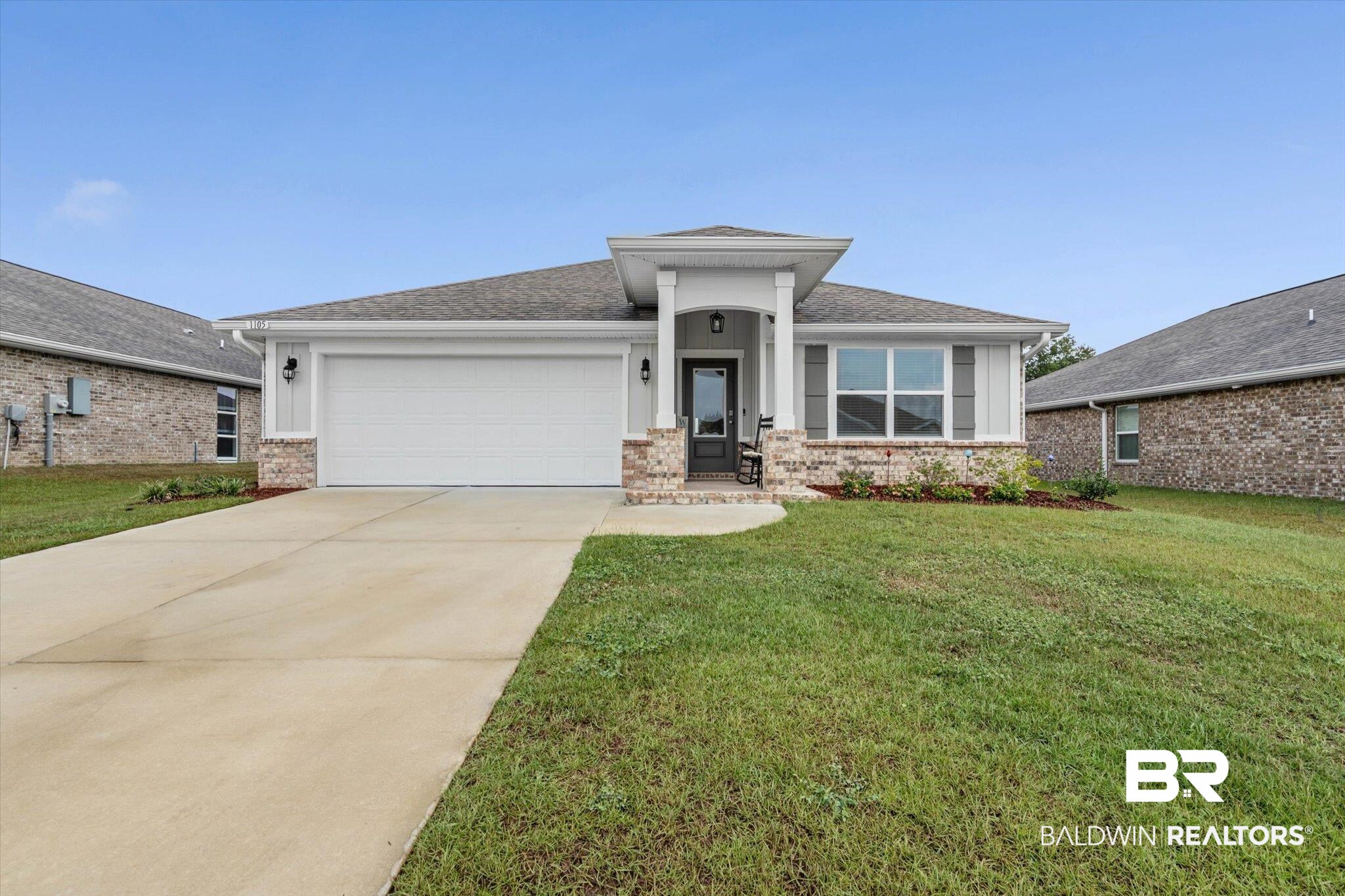 1105 Hayward Loop Foley, AL 36535 - Photo 23 of 30 Prairie-style house featuring a front lawn, concrete driveway, a shingled roof, an attached garage, and brick siding