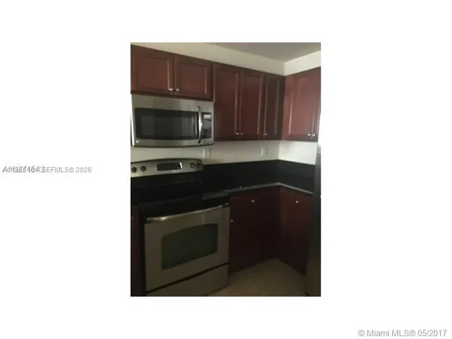 a kitchen with a sink and a microwave