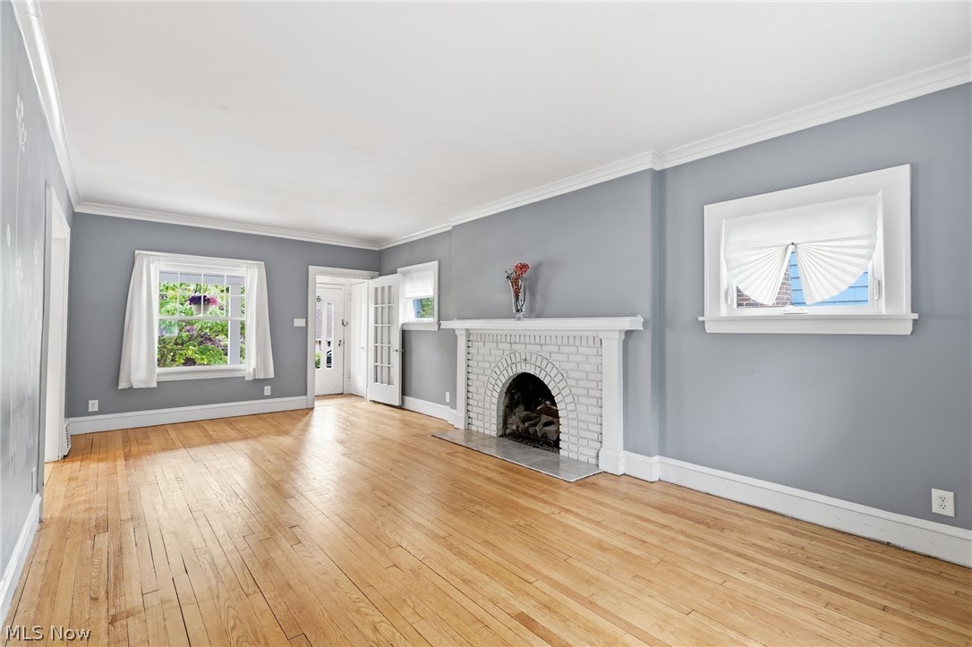 3511 Northcliffe Road Cleveland, OH 44118 - Photo 4 of 46 Hardwood flooring, white brick fireplace with hearth, white mantel, double French doors, and crown molding