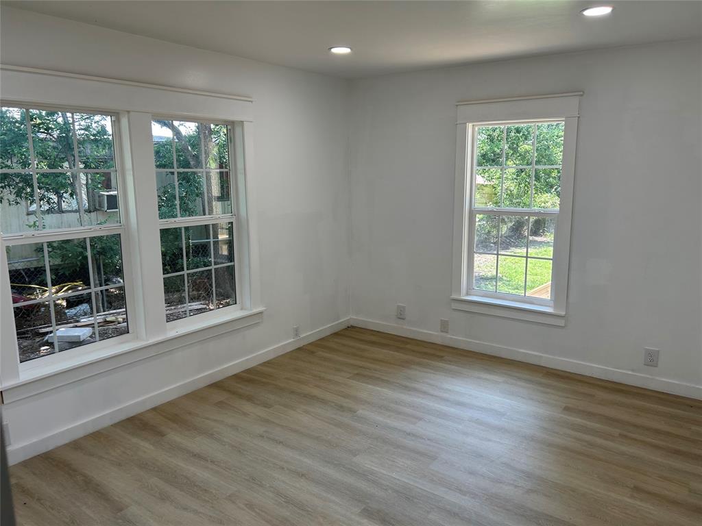 206 North 3rd Street Lott, TX 76656 - Photo 4 of 7 a view of an empty room with wooden floor and a window