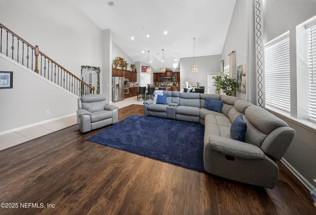 a living room with furniture or wooden floor and a potted plant